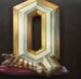 Symbol Písmeno Q automatu Divine Showdown od Play’n GO